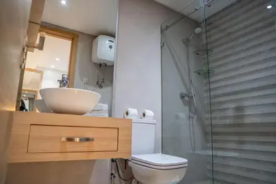 a bathroom with a toilet and a sink and a shower at CAN 2025 - T2 design Gare de Marrakech - Guéliz-Hivernage - WiFi in Marrakech
