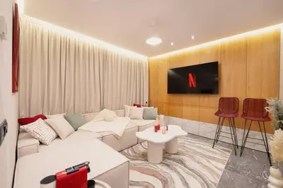 a living room with a white couch and a tv at Cocooning escape Relaxation, design and serenity in Marrakech