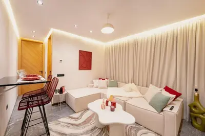 a living room with a white couch and a table at Cocooning escape Relaxation, design and serenity in Marrakech