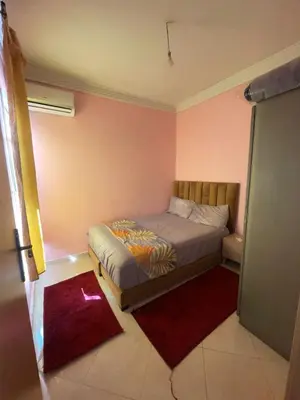a bedroom with a bed in a room with pink walls at Abwab guiliz in Marrakech