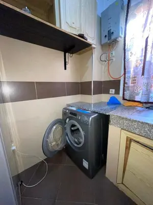 a washing machine in a kitchen next to a counter at Abwab guiliz in Marrakech
