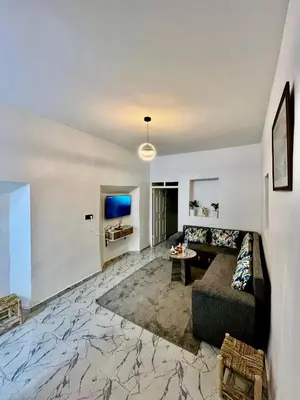 a living room with a couch and a tv at Mdina Studio- 5 min de la place in Marrakech