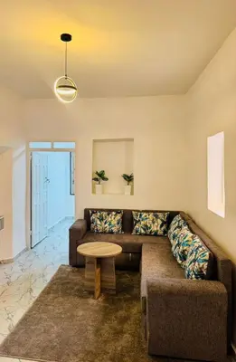 a living room with a couch and a table at Mdina Studio- 5 min de la place in Marrakech