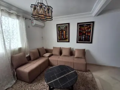 a living room with a couch and a table at Appartement a louer 2 chambres in Marrakech