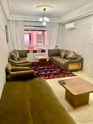 a living room with two couches and a table at Charmant, terrasse intime, près du centre in Marrakech