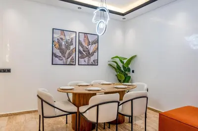 a dining room with a wooden table and chairs at Guéliz 7 Appartements in One Building in Marrakech