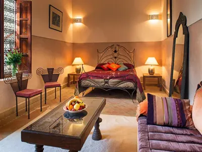 a bedroom with a bed with a bowl of fruit on a coffee table at Riad Darhani - Private use option - in Marrakech