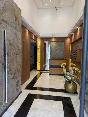 a lobby of a hotel with a vase of flowers at Appartement duplex haut standing Guelyz in Marrakech