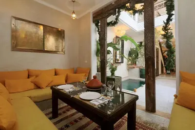 a living room with a couch and a table at Riad Beata - Private use option - in Marrakech