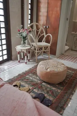a room with a chair and a table with shoes at Riad Beata - Private use option - in Marrakech