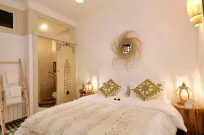 a bedroom with a large white bed and a mirror at Riad Beata - Private use option - in Marrakech