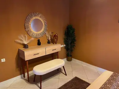 a dressing table with a mirror and a stool in a room at Le Patio Marrakchi in Marrakech