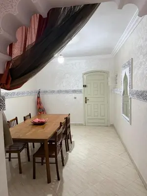 a dining room with a wooden table and chairs at Modern Flat Gueliz ,City center Marrakech in Marrakech