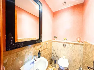 a bathroom with a sink and a mirror at Oasis Palmeraie - Piscines & terrasses in Marrakech