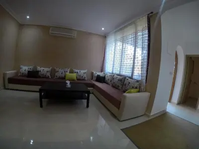 a living room with a couch and a table at Étoile de marrakech in Marrakech