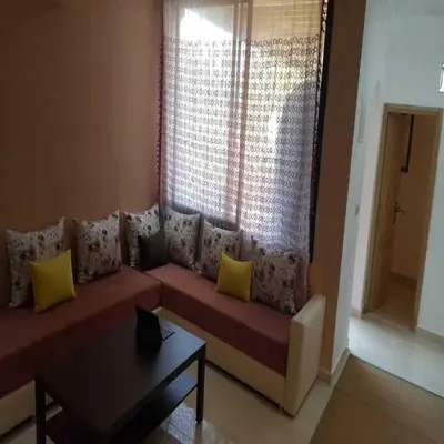 a living room with a red couch with yellow pillows at Étoile de marrakech in Marrakech