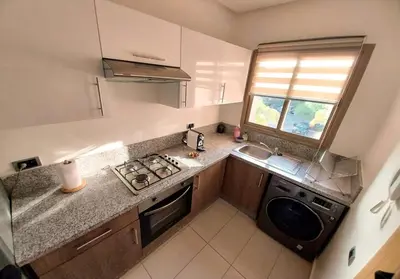 a small kitchen with a sink and a stove at Luxury Apartments in Marrakech