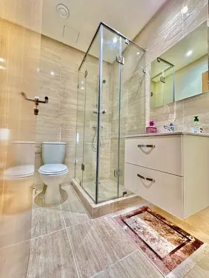 a bathroom with a toilet and a glass shower at Luxury Apartments in Marrakech