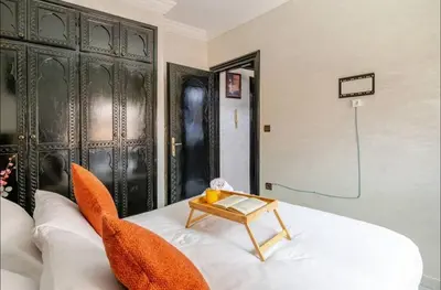 a room with a bed with a table on it at Cocon Chic et Élégant Quartier Hivernage in Marrakech