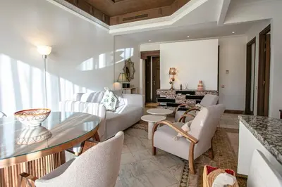 a living room with a couch and a table at Marrakech Palmeraie 3, 2-bedroom appartement, ,res with pool in Marrakech