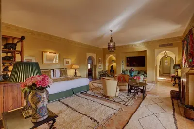 a bedroom with a bed and a living room at Casa Memoria Marrakech in Marrakech