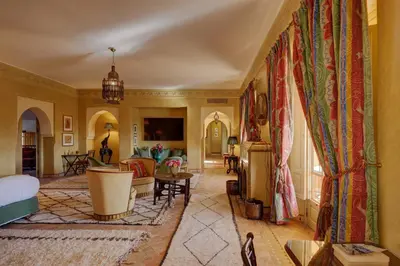 a room with a bed and a living room at Casa Memoria Marrakech in Marrakech