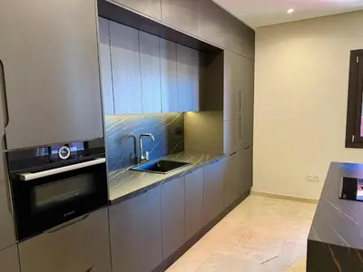 a kitchen with a sink and a microwave at Modern apartment in Gueliz Plaza in Marrakech