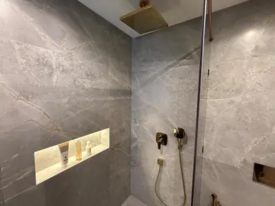 a bathroom with a shower with a glass door at Modern apartment in Gueliz Plaza in Marrakech