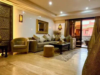 a living room with a couch and a table at Moroccan style Soltana pool & central internet in Marrakech