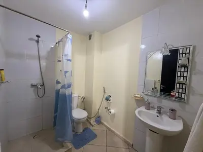 a bathroom with a toilet and a sink and a shower at Calm & Comfortable Appartement Close to Airport in Marrakech