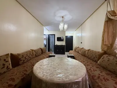 a living room with a couch and a table at Calm & Comfortable Appartement Close to Airport in Marrakech
