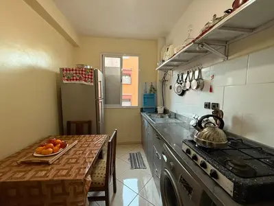a kitchen with a stove and a table with a tea kettle at Calm & Comfortable Appartement Close to Airport in Marrakech