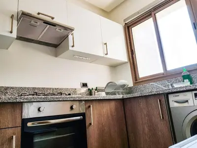 a kitchen with a sink and a stove top oven at Luxury Apartments in Marrakech