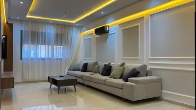 a living room with a couch and a tv at Moderne spacieux cosy in Marrakech