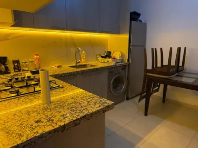 a kitchen with a sink and a washing machine at Moderne spacieux cosy in Marrakech