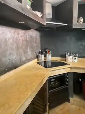 a kitchen with a wooden counter top and a stove at Riad coup de coeur, Medina, Marrakech in Marrakech