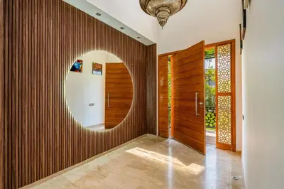 a hallway with a round mirror on a wooden wall at Golf Resort 4BR Villa Heated Pool Free Pickup in Marrakech