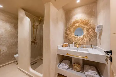 a bathroom with a sink and a toilet and a mirror at Secure Stylish Flat Gueliz Pool WiFi Parking in Marrakech