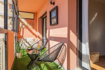 a balcony with a chair and a table at Secure Stylish Flat Gueliz Pool WiFi Parking in Marrakech