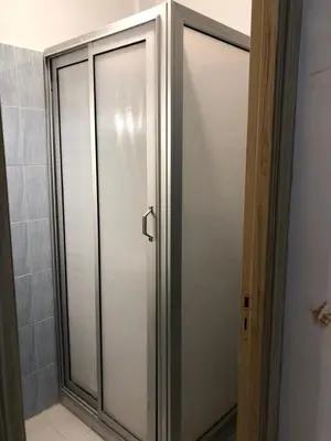 a shower stall with a glass door in a bathroom at Majorelle louza in Marrakech