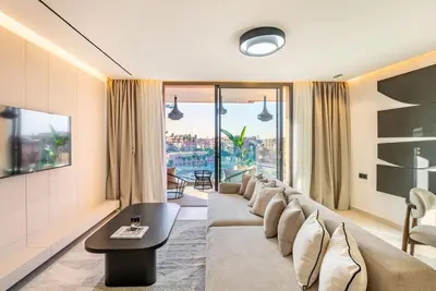 a living room with a couch and a table at New apartment, quiet and well located with balcony in Marrakech