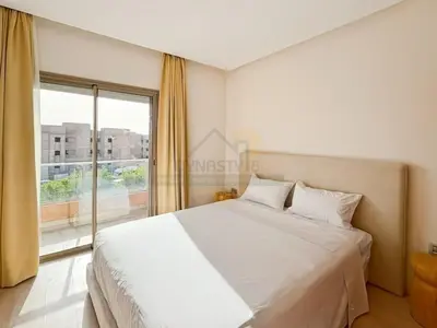 a bedroom with a large bed and a large window at Elegant Studio-Prestigia Agate in Marrakech