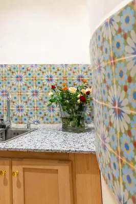 a kitchen with a vase of flowers on a counter at Riad Dar 77 in der Medina mit Terrasse in Marrakech