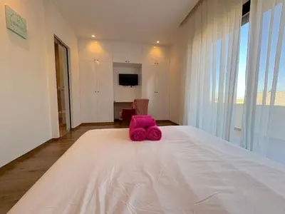 a pink stuffed animal sitting on top of a bed at Palais Naya in Marrakech