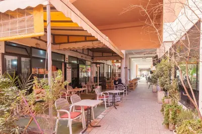 an empty patio with tables and chairs in a building at New Stylish Riad - 4BR with Pool Access Free Breakfast & Airport Pickup in Marrakech