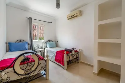 a bedroom with two beds and a window at New Stylish Riad - 4BR with Pool Access Free Breakfast & Airport Pickup in Marrakech