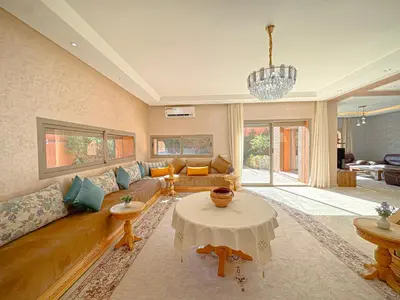 a living room with a couch and a table at Villa Andalus - Piscine privée & Suite Parentale in Marrakech