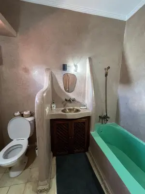 a bathroom with a toilet and a sink and a tub at Riad Marhaba Kasbah in Marrakech