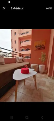 a room with a table with a red hat on it at Appart cosy & chic premium Village, 5 piscines in Marrakech
