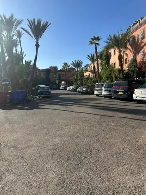 a street with cars parked on the side of the road at Studio tranquille dans le village touristique in Marrakech